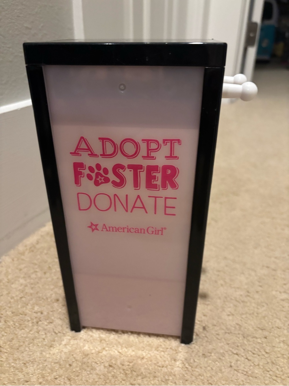 American Girl Pink and Black 'Adopt Foster Donate' Donation Shelf